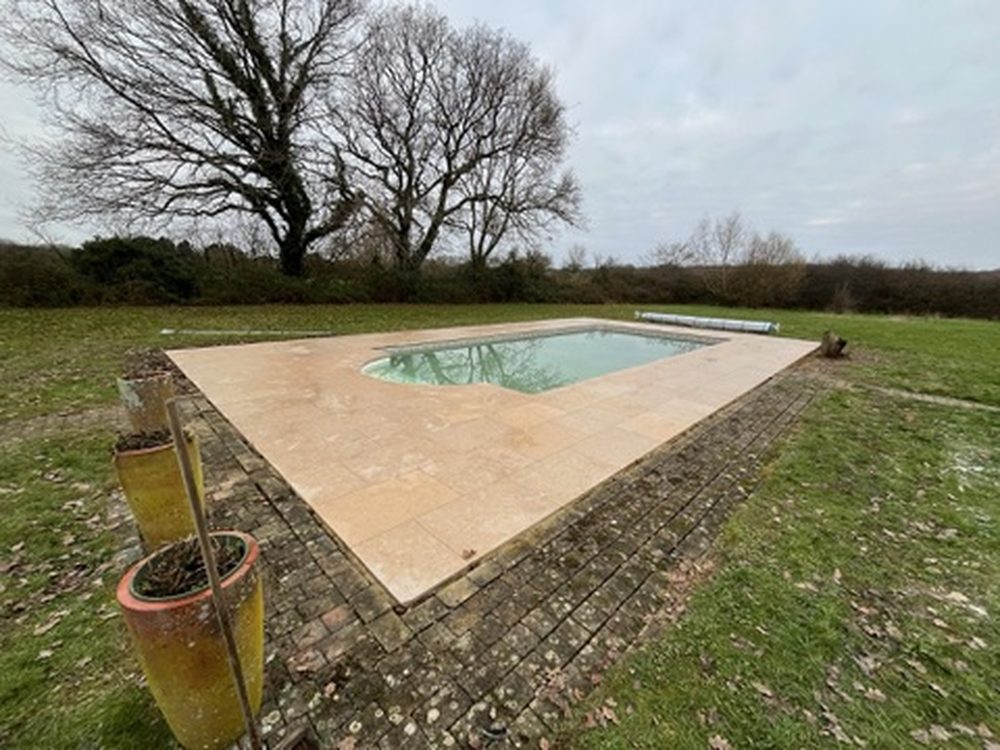 Travertine pool surround in a West Sussex garden